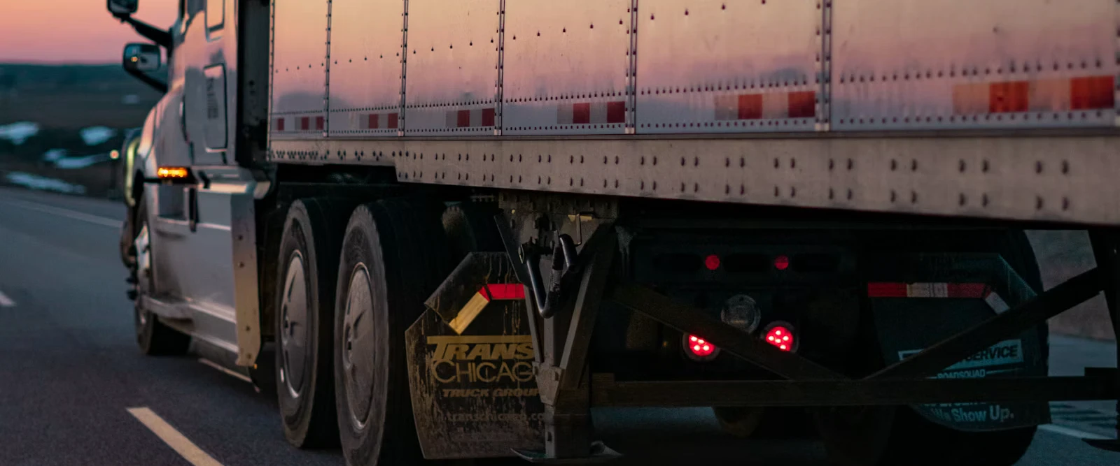 Loaded cargo truck on a highway with mountains in the background